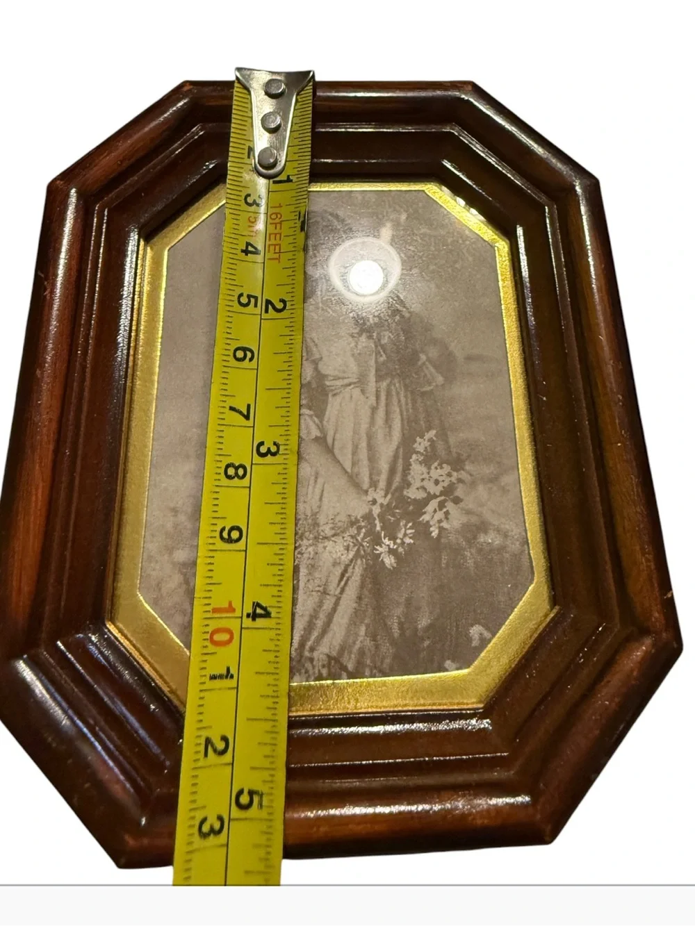 vintage octagonal wood-finish photo frame features a classic portrait insert and